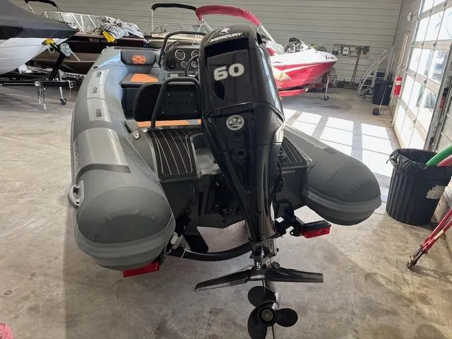 Slide: The Image of 2023 Highfield Sport 390 boat with Mercury 60 outboard motor in a showroom. - 8