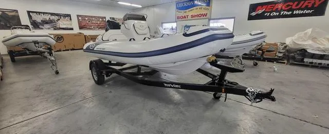 Slide: The Image of 2024 Walker Bay Venture 14 4 Seat boat displayed in showroom on trailer. - 4