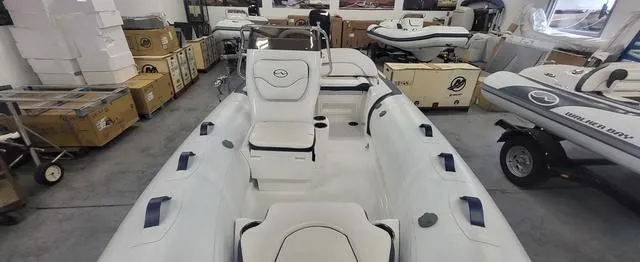 Slide: The Image of 2024 Walker Bay Venture 14 4 Seat boat in showroom, featuring spacious seating and modern design. - 5