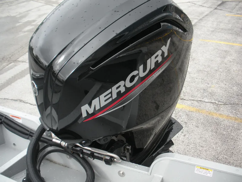 Slide: The Image of 2024 Smoker Craft Freedom 180 SC with Mercury outboard motor on a concrete surface. - 12