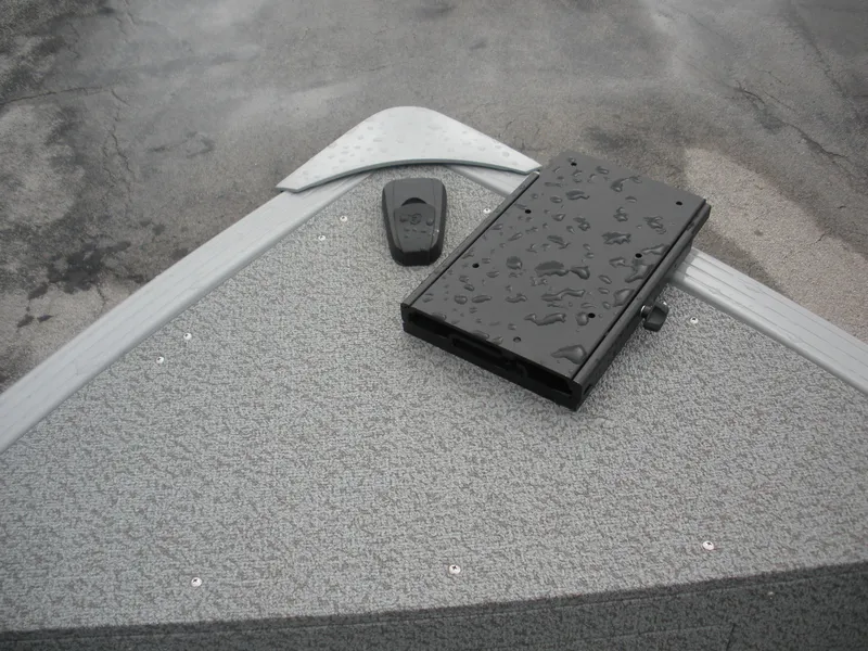 Slide: The Image of 2024 Smoker Craft Freedom 180 SC boat deck with wet surface and equipment. - 2