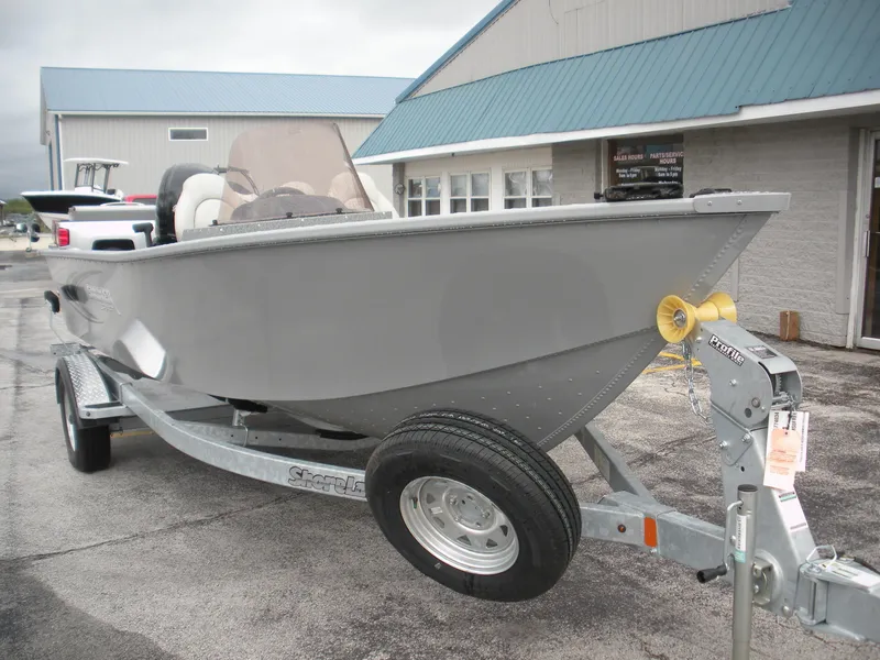 Slide: The Image of 2024 Smoker Craft Freedom 180 SC boat on trailer, parked outside a building. - 3
