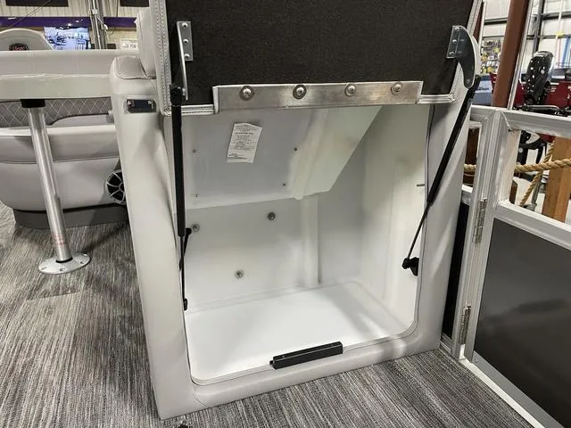 Slide: The Image of Open storage compartment in 2025 Ranger 220FC boat interior. - 10