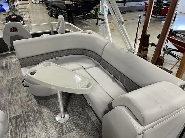 Slide: The Image of Luxurious seating area on 2025 Ranger 220FC boat with modern design and table. - 11