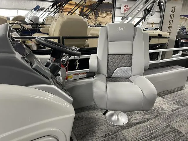 Slide: The Image of 2025 Ranger 220FC boat interior with modern captain's chair and steering console. - 12