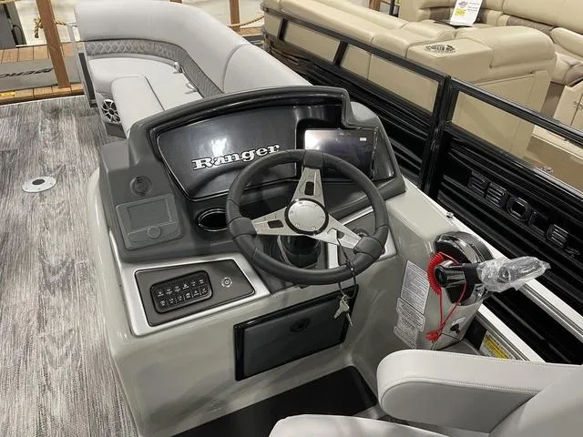 Slide: The Image of 2025 Ranger 220FC boat dashboard with steering wheel and control panel. - 14