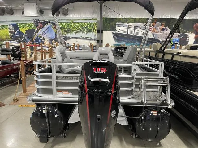Slide: The Image of 2025 Ranger 220FC pontoon boat with Mercury 115 engine in showroom. - 20