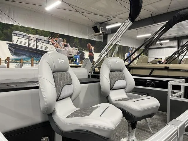Slide: The Image of 2025 Ranger 220FC boat interior with plush seating in a showroom setting. - 22