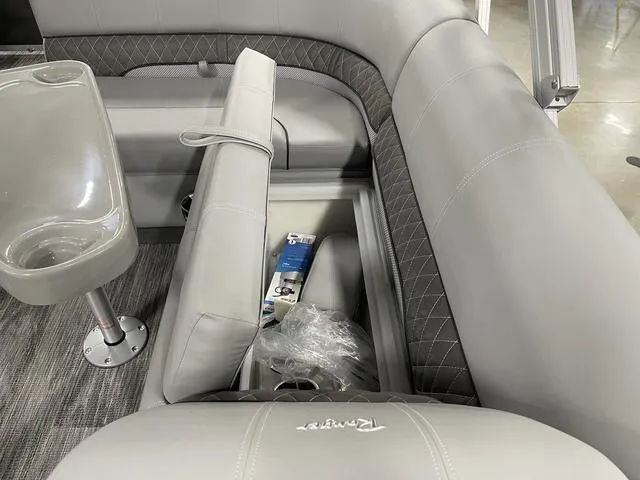 Slide: The Image of 2025 Ranger 220FC boat interior with gray seating and storage compartment. - 23