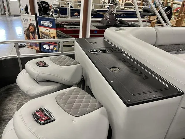 Slide: The Image of 2025 Ranger 220FC boat interior with cushioned seating and storage compartments. - 25