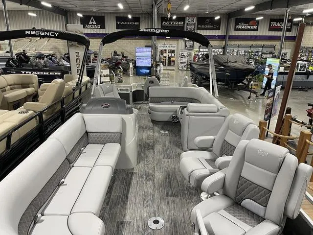 Slide: The Image of 2025 Ranger 220FC pontoon boat with luxurious seating in a showroom. - 3