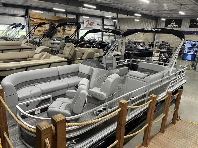 Slide: The Image of 2025 Ranger 220FC pontoon boat displayed in a showroom with luxurious seating. - 4