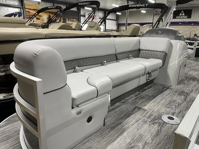 Slide: The Image of 2025 Ranger 220FC boat interior with gray seating and wood-style flooring. - 7
