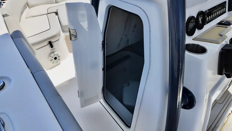 Slide: The Image of 2021 Sea Fox 248 Commander boat interior with open storage compartment and control panel. - 10