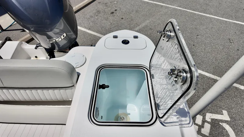 Slide: The Image of 2021 Sea Fox 248 Commander boat with open storage compartment and visible engine. - 15