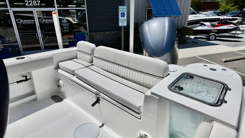 Slide: The Image of 2021 Sea Fox 248 Commander boat interior with cushioned seating and storage compartment. - 16