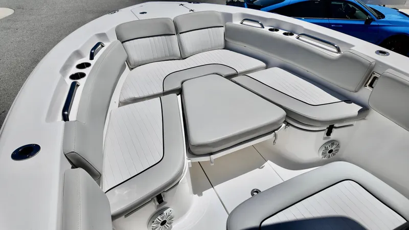 Slide: The Image of 2021 Sea Fox 248 Commander boat interior with cushioned seating and cup holders. - 19