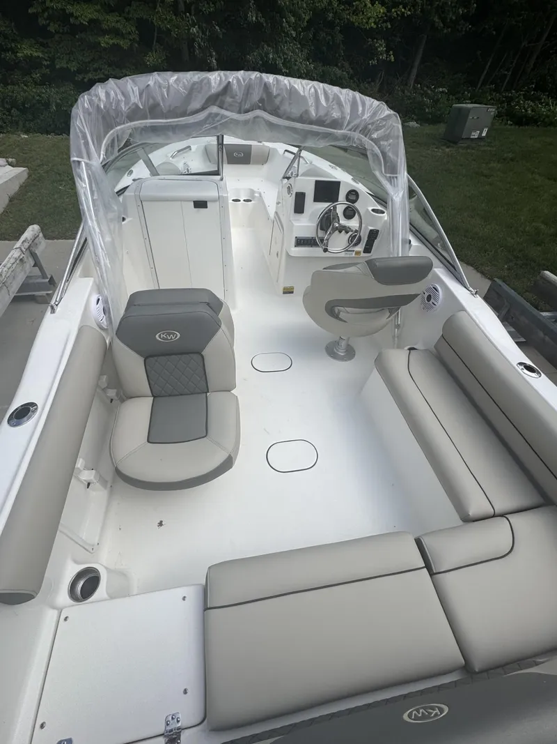 Slide: The Image of 2025 Key West 203 DFS boat interior with seating and steering console. - 4