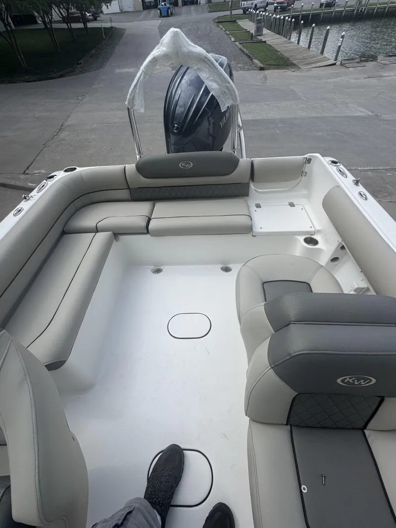 Slide: The Image of 2025 Key West 203 DFS boat interior with cushioned seating and outboard motor. - 8