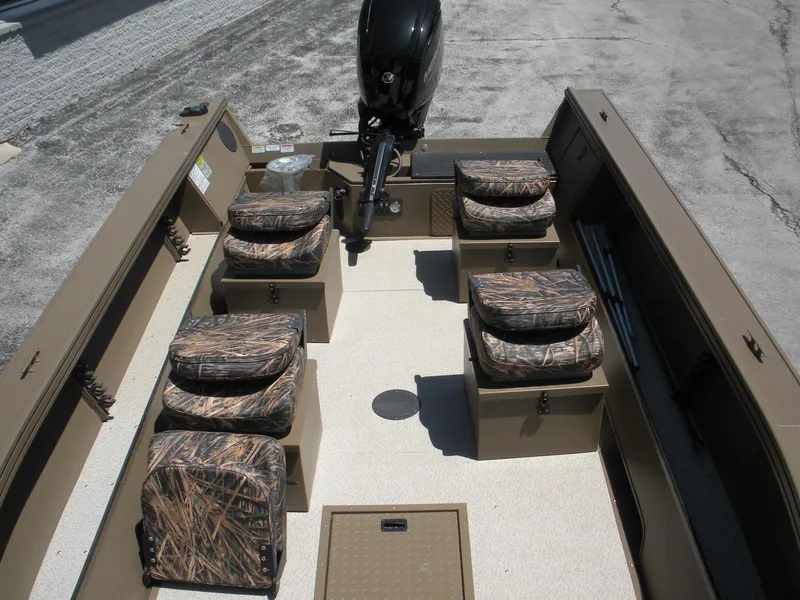 Slide: The Image of 2024 Smoker Craft Pro Sportsman 1872 T boat interior with camo seating and motor. - 3
