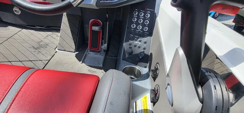 Slide: The Image of 2021 Vexus VX20 boat interior with red seating and control panel. - 13