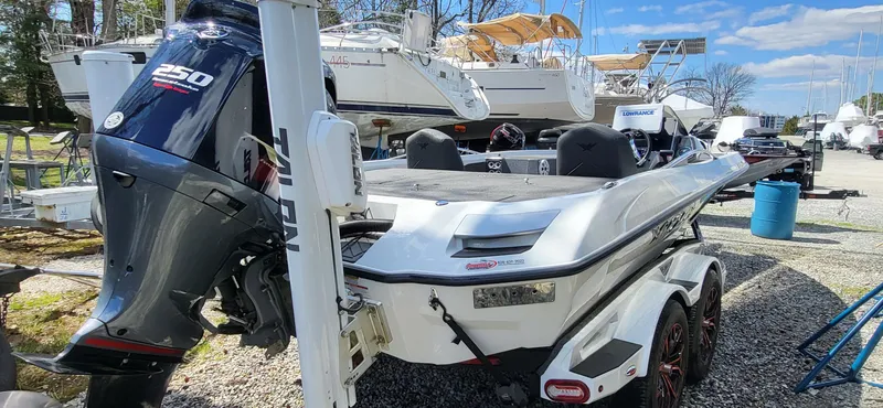 Slide: The Image of 2021 Vexus VX20 boat with powerful 250 horsepower engine, parked in a marina. - 7