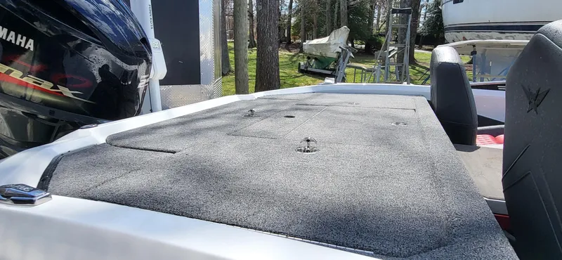 Slide: The Image of 2021 Vexus VX20 boat deck with Yamaha engine, parked outdoors. - 9