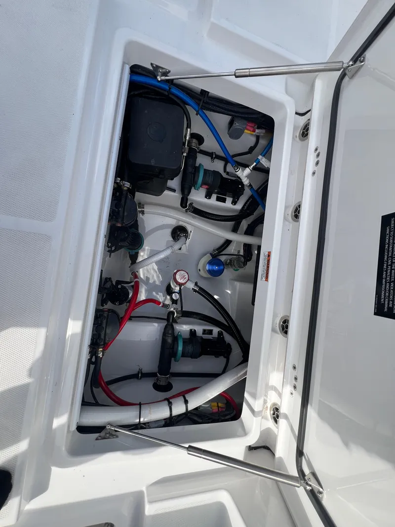 Slide: The Image of 2025 Blackfin 252 CC boat compartment with wiring and mechanical components. - 13