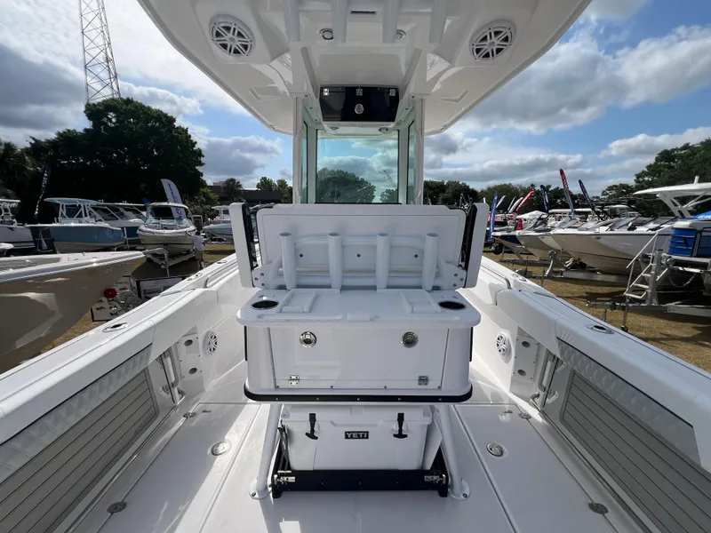 Slide: The Image of 2025 Blackfin 252 CC boat interior with open storage, surrounded by other boats. - 14