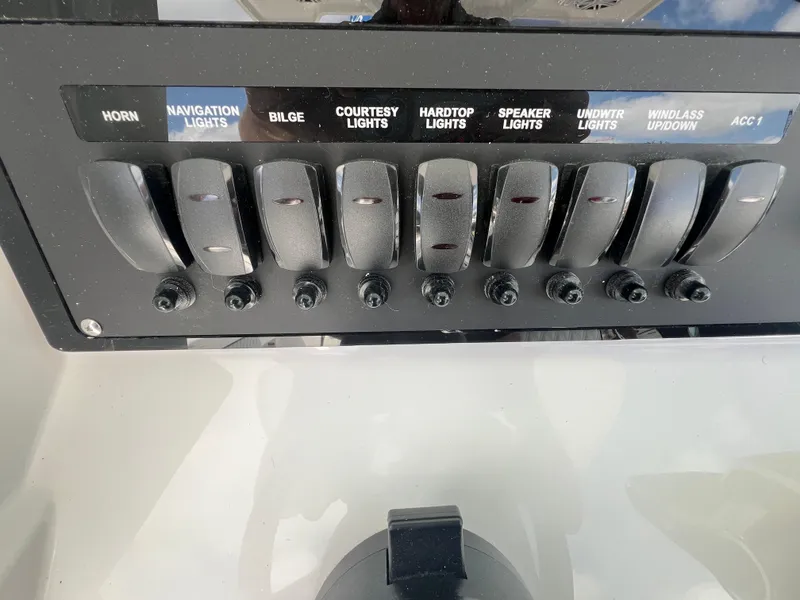 Slide: The Image of Control panel of 2025 Blackfin 252 CC boat with labeled switches for various functions. - 16