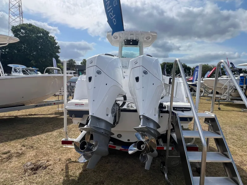 Slide: The Image of 2025 Blackfin 252 CC boat with dual outboard engines displayed outdoors. - 5