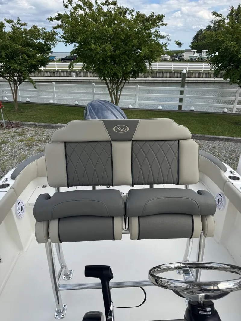 Slide: The Image of 2025 Key West 203 FS boat interior with cushioned seating and steering wheel. - 4