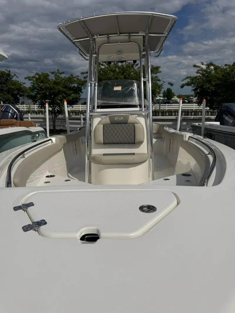 Slide: The Image of 2025 Key West 203 FS boat with T-top, docked under cloudy sky. - 5