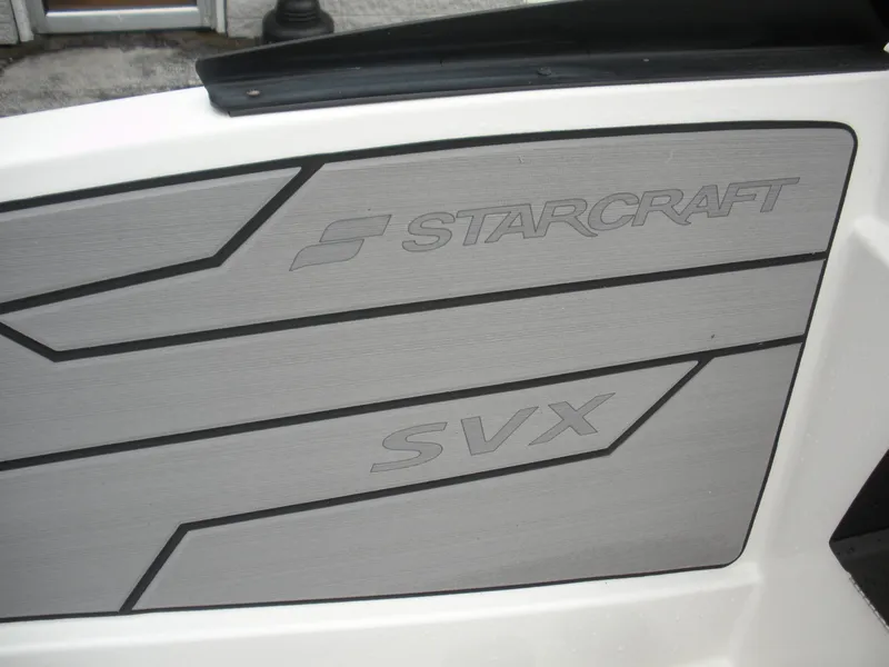 Slide: The Image of 2024 Starcraft SVX 190 OB DC boat interior panel with logo and design. - 10