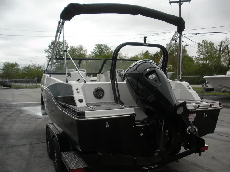 Slide: The Image of 2024 Starcraft SVX 190 OB DC boat with outboard motor, parked on a trailer. - 12