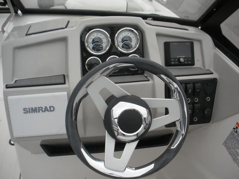 Slide: The Image of 2024 Starcraft SVX 190 OB DC boat dashboard with steering wheel and gauges. - 4