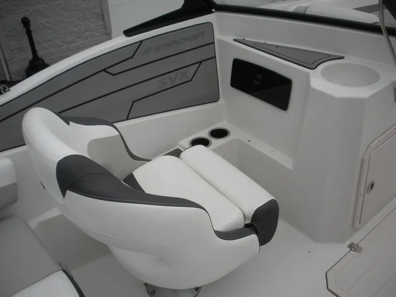 Slide: The Image of 2024 Starcraft SVX 190 OB DC boat interior with white and gray seating. - 6