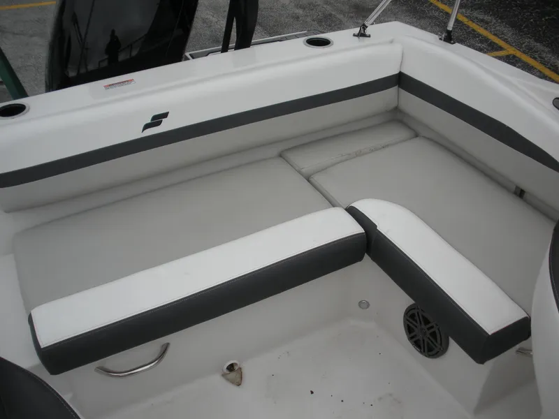 Slide: The Image of 2024 Starcraft SVX 190 OB DC boat interior with cushioned seating and cup holders. - 7