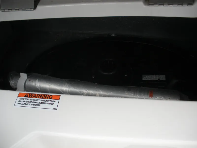 Slide: The Image of 2024 Starcraft SVX 190 OB DC boat compartment with safety warning label. - 9