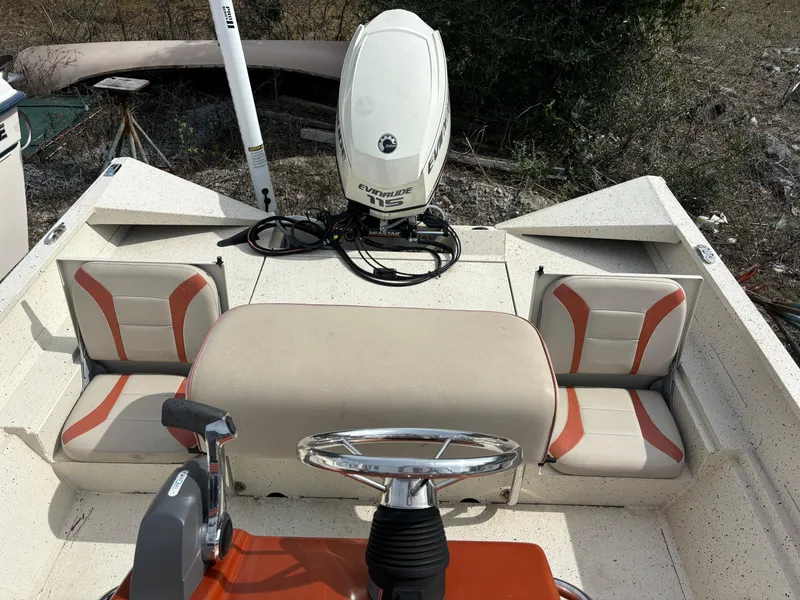 Slide: The Image of 2016 Alumacraft 2072 Bay boat interior with seating and Evinrude outboard motor. - 11