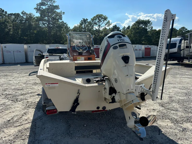 Slide: The Image of 2016 Alumacraft 2072 Bay boat with outboard motor in a parking area. - 2