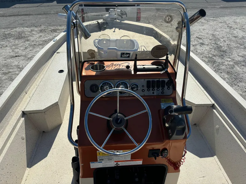 Slide: The Image of 2016 Alumacraft 2072 Bay boat dashboard with steering wheel and control panel. - 6