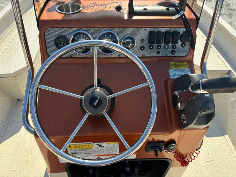 Slide: The Image of 2016 Alumacraft 2072 Bay boat dashboard with steering wheel and control panel. - 7