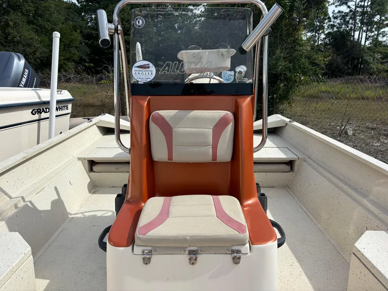 Slide: The Image of 2016 Alumacraft 2072 Bay boat interior with orange and white seating. - 8