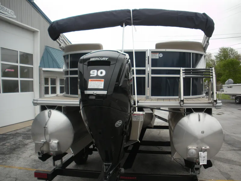 Slide: The Image of 2024 Sylvan Mirage 820 LZ pontoon boat with Mercury 90 engine, parked outside a building. - 10