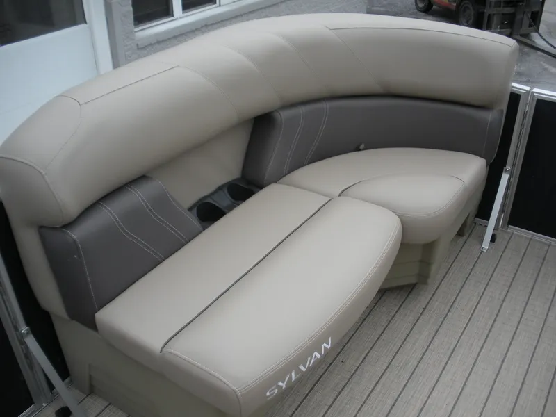 Slide: The Image of 2024 Sylvan Mirage 820 LZ boat seating with beige and gray upholstery. - 2