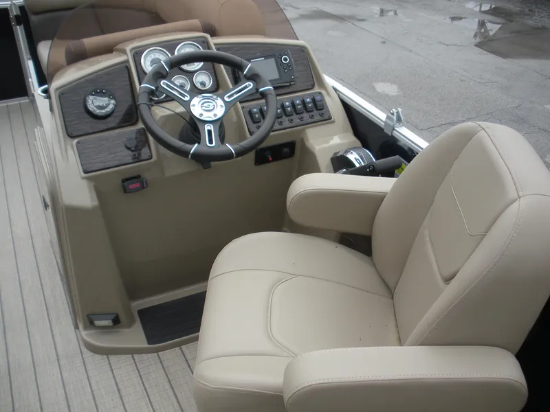 Slide: The Image of 2024 Sylvan Mirage 820 LZ boat interior with steering wheel and beige captain's chair. - 4