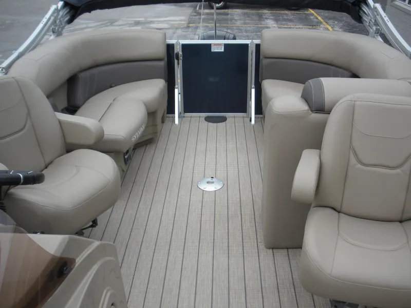Slide: The Image of 2024 Sylvan Mirage 820 LZ boat interior with beige seating and spacious deck. - 5
