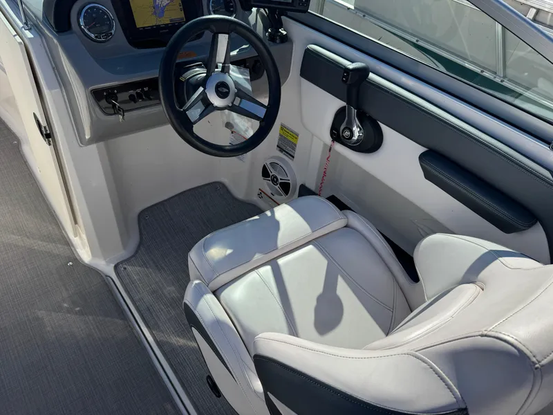 Slide: The Image of 2020 Chaparral 21 SSi Ski & Fish OB boat interior with steering wheel and seating. - 12