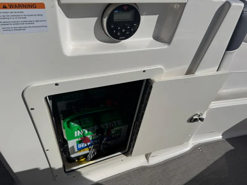 Slide: The Image of 2020 Chaparral 21 SSi Ski & Fish OB boat battery compartment with Interstate battery visible. - 16
